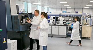 Intertek employees in lab coats working in a lab