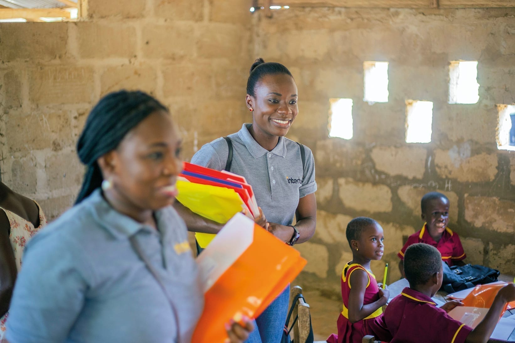 Intertek colleagues working with folders in hand