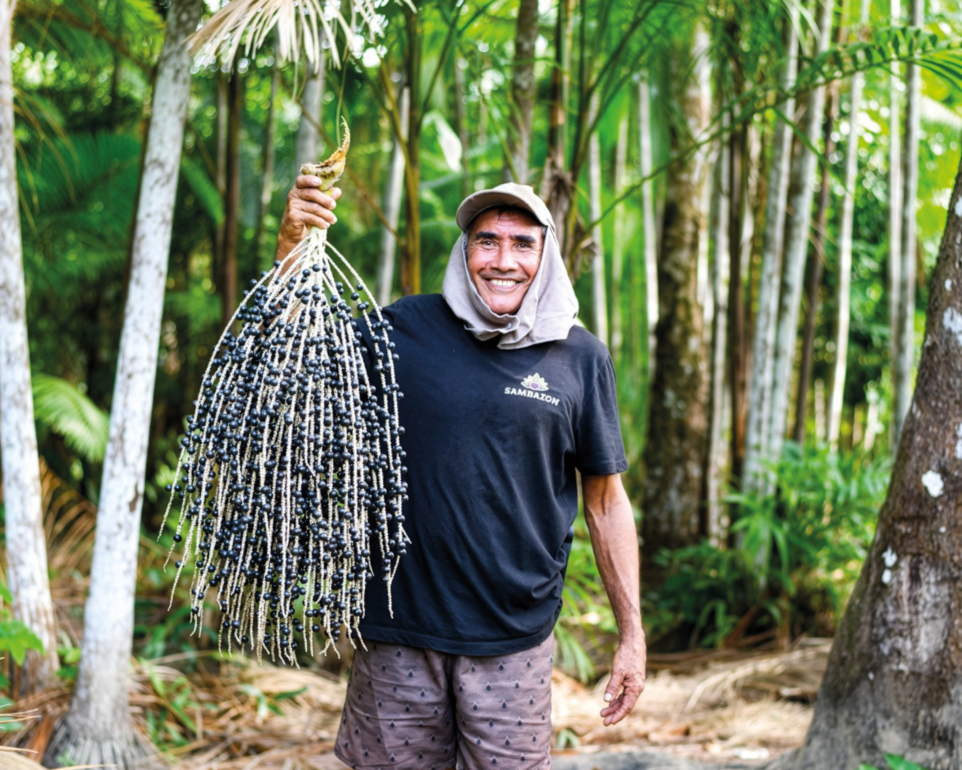 Famer showing ethically sourced açaí, hand-harvested by local farmers